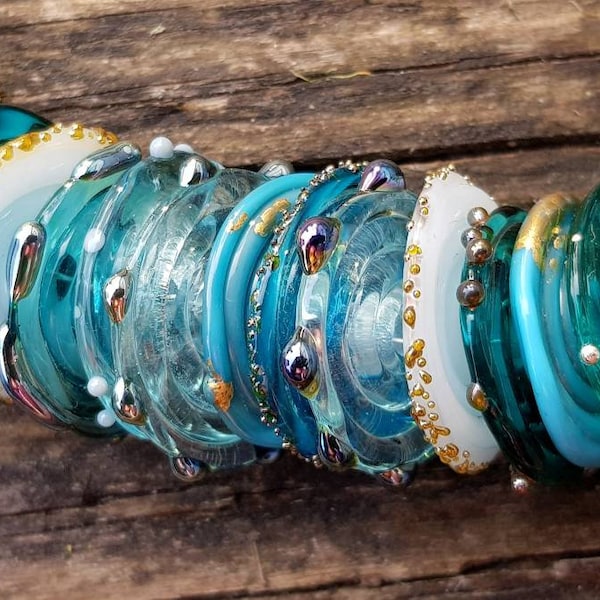 Organic style handmade lampwork murano glass disc beads in shades of aqua, teal and turquoise with 24k gold leaf, droplet and frit texture