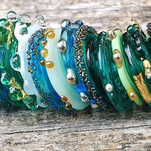 Handmade luxurious artisan glass disc beads in shades of teal, turquoise blue and emerald green textured with 24 gold leaf and fine silver