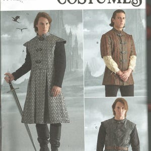 May include: Simplicity Costumes pattern S9593 featuring three variations of a tunic. View A is a long, patterned grey tunic with a high collar. View B is a brown short-sleeved tunic with buckles. View C is a dark grey textured tunic with a belt.