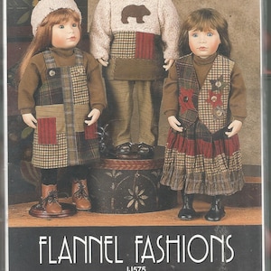 May include: A sewing pattern envelope titled FLANNEL FASHIONS IJ575 by Donna Martin for Indygo Junction, Inc. The cover features three dolls wearing flannel outfits including a jumper, an appliqued patchwork pullover, pants, a vest, a hat, and a skirt for 17-19 inch dolls.