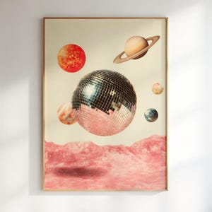 May include: A rectangular wall art print featuring a large, central disco ball floating above a textured, pink landscape. Surrounding the disco ball are various celestial bodies, including a ringed planet, a red sun, and smaller planets.