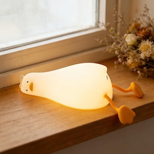 May include: A set of three ceramic mugs with a speckled, matte finish. The mugs are in shades of cream, light brown, and dark brown. Each mug has a simple, minimalist design, perfect for coffee or tea.