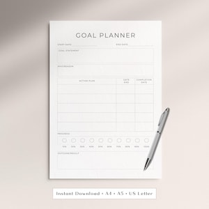 May include: A white goal planner with the title "GOAL PLANNER" at the top. The planner includes sections for start and end dates, goal statements, action plans, and progress tracking. A silver pen rests on the right side of the planner. The text "Instant Download • A4 • A5 • US Letter" is at the bottom.