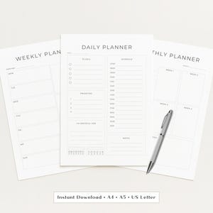 May include: A set of three white paper planners: weekly, daily, and monthly. The daily planner is in the center, with sections for to-dos, schedule, priorities, and notes. A silver pen rests on the monthly planner. The text "Instant Download • A4 • A5 • US Letter" is at the bottom.