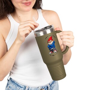 May include: A white ceramic mug with a black handle and the text "But First, Coffee" in a bold, black font. The mug is filled with a dark liquid, likely coffee, and sits on a light-coloured surface.