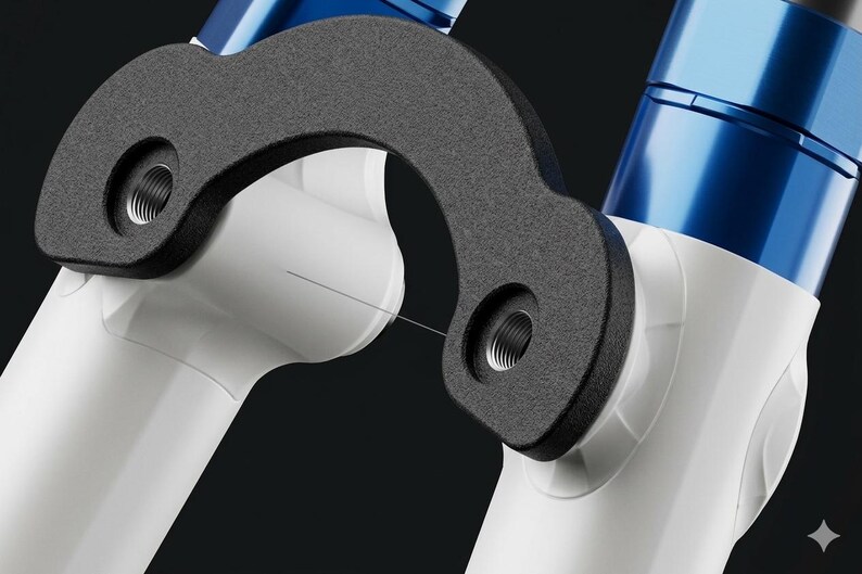 May include: Close-up of a bicycle suspension fork with a black, curved component and white tubes. The fork has blue accents and threaded holes for mounting. The design is modern and sleek.