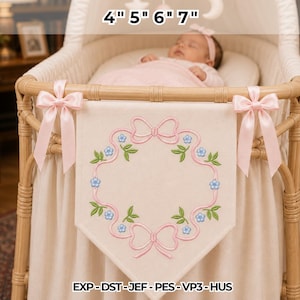 May include: A cream-colored fabric banner featuring an embroidered pink ribbon frame with blue flowers and green leaves, accented by two pink satin bows. The banner displays the text 4" 5" 6" 7" and EXP-DST-JEF-PES-VP3-HUS.