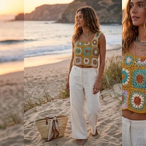 May include: A woman wearing a colorful crochet crop top with a square neckline and white pants stands on a sandy beach. A straw tote bag with a patterned scarf sits nearby. The background features the ocean and a sunset.