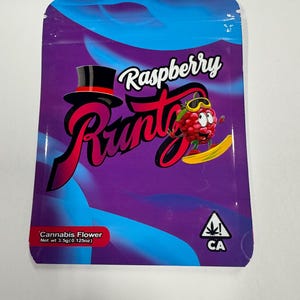 May include: A purple and blue bag with the text "Raspberry Runtz" in a stylized font. The bag features a cartoon raspberry character wearing goggles and a top hat. The bottom of the bag reads "Cannabis Flower Net wt 3.5g (0.125oz)" with a CA symbol.