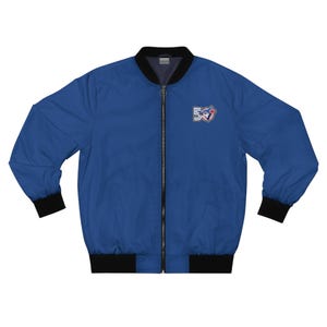 May include: A blue bomber jacket with a black collar, cuffs, and hem. The jacket features a zipper closure and a logo patch on the upper left chest. The logo includes the number "50" and a bird emblem.