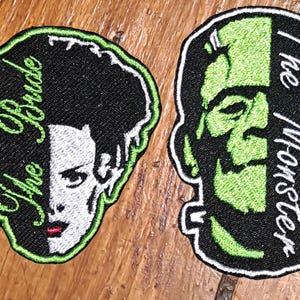 May include: Two embroidered patches featuring split-face designs. One patch depicts a woman with black hair and the text The Bride, while the other shows a green-skinned creature with bolts and the text The Monster, both with black and green borders.