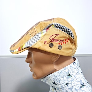 May include: A white ceramic mug with a black handle and the text "But First, Coffee" in a bold, black font. The mug is set against a blurred background, highlighting its clean design.