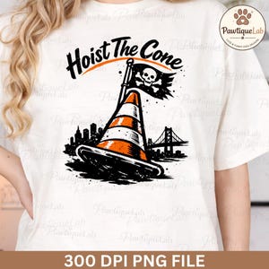May include: White t-shirt featuring a graphic design with the text "Hoist The Cone". The design includes a traffic cone with a pirate flag, a cityscape, and a bridge. The shirt is a 300 DPI PNG file.