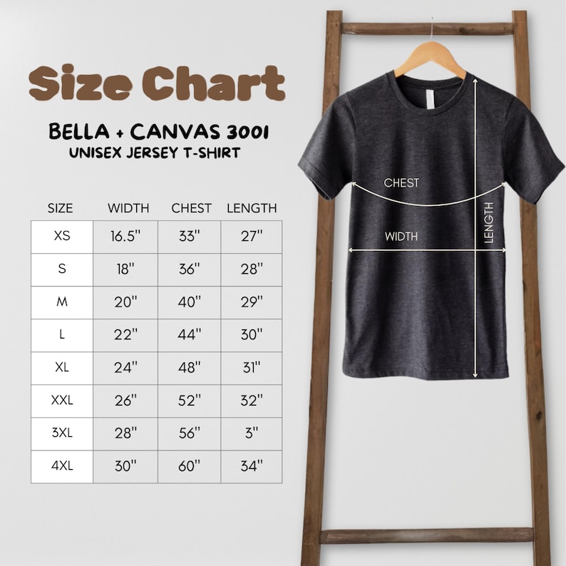 May include: A dark gray Bella + Canvas 3001 unisex jersey t-shirt hangs on a wooden rack. A size chart is displayed, showing measurements in inches for sizes XS to 4XL, including width, chest, and length. The chart is labeled "Size Chart".