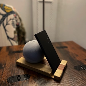 May include: A rustic wooden sign with the text "Welcome to our home" in white lettering. The sign features a distressed finish and a simple, inviting design, perfect for a front porch or entryway.