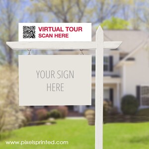 May include: White real estate sign with a QR code and the text "VIRTUAL TOUR SCAN HERE" on the top and a blank white sign with the text "YOUR SIGN HERE" hanging below.