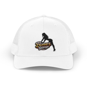 May include: White trucker hat with a mesh back and a curved brim. The hat features a black silhouette of a woman and the text "Boner Garage" in a stylized font with red, yellow, and orange accents.