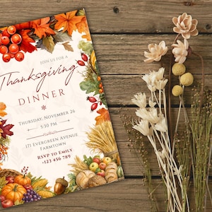 May include: A rectangular Thanksgiving dinner invitation card featuring a watercolor border of autumn leaves, red berries, pumpkins, wheat, and grapes. The text reads: Join us for a Thanksgiving Dinner, Thursday, November 26, 5:30 PM, 171 Evergreen Avenue, Farmtown, RSVP to Emily +123 456 789.