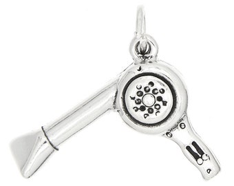 May include: Silver charm in the shape of a hair dryer. The charm has a detailed design and is perfect for adding a touch of personality to a bracelet or necklace.