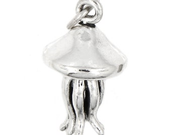 May include: A silver charm in the shape of a jellyfish. The charm has a rounded top and multiple tentacles.