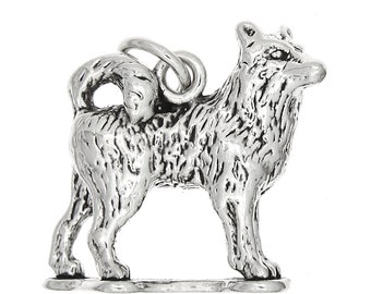 May include: A silver charm in the shape of a standing husky dog. The charm has a detailed, textured surface and a loop for attaching to a bracelet or necklace.