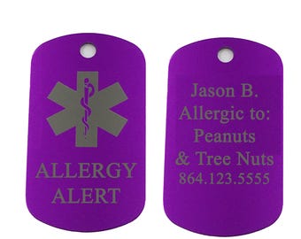 May include: Two purple medical alert dog tags. One tag has a grey medical symbol and the words "ALLERGY ALERT." The other tag lists the name "Jason B." and allergies to peanuts and tree nuts, with a phone number.