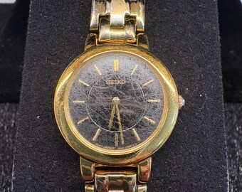 Montre-bracelet vintage Seiko 1N00 1E19 pour femme à quartz doré