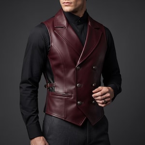May include: A double-breasted vest in deep burgundy faux leather featuring a wide lapel, six dark buttons arranged in two columns, and a side adjustment strap with a buckle. The garment is worn over a solid black long-sleeved button-down shirt.
