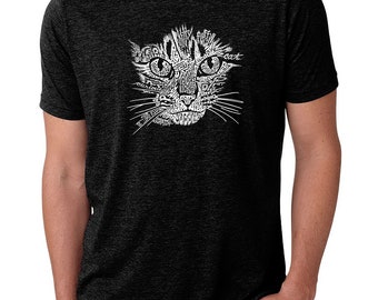 May include: A black t-shirt with a white graphic of a cat's face made up of words related to cats. The words include "meow", "purr", "cuddle", "play", "love", "sleep", "scratch", "kitten", "catnip", and "tail".