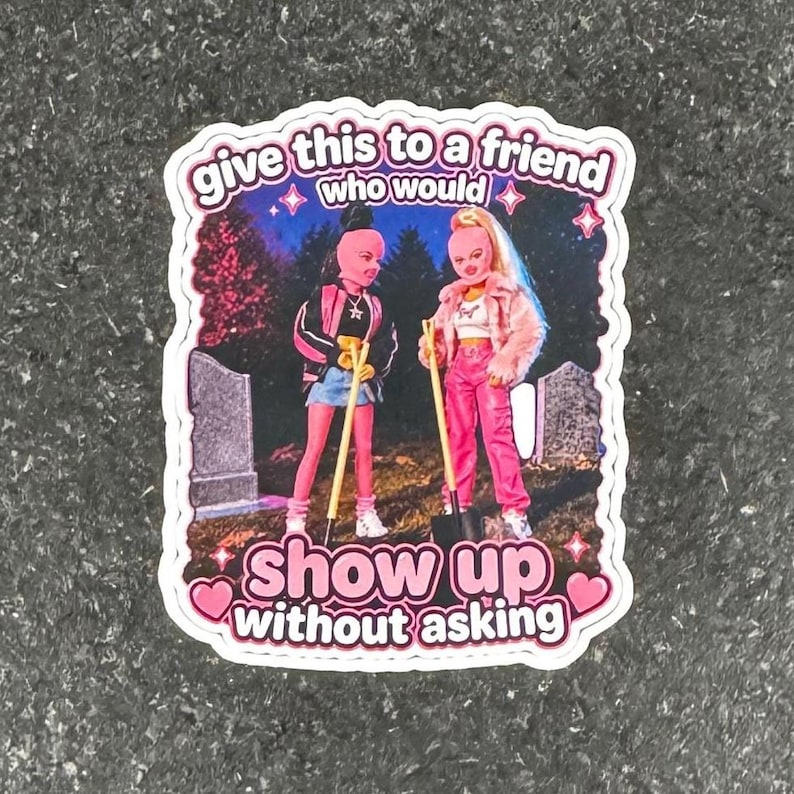 May include: A sticker with a pink and white border featuring two doll figures with shovels in a graveyard scene. The sticker has the text "give this to a friend who would" and "show up without asking."