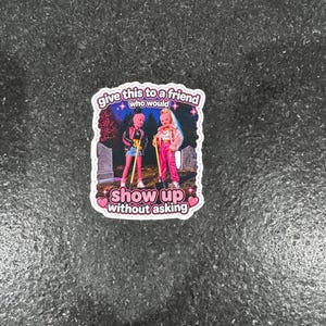 May include: A sticker featuring two cartoon figures standing in front of a graveyard. The text on the sticker reads "give this to a friend who would show up without asking."