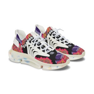 May include: A pair of athletic sneakers with a colorful, patterned design. The shoes feature a black base with pink, orange, and purple accents. White laces and a clear sole complete the design.
