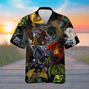 May include: Short-sleeved button-down shirt featuring a fantasy dragon design. The shirt showcases various colorful dragons with dice on a dark background. The dragons have red, gold, green, and white wings. The shirt has a V-neck collar.