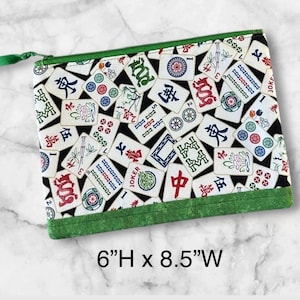 May include: A set of three ceramic mugs with a speckled, matte finish. The mugs are in shades of cream, light gray, and dark gray. Each mug has a simple, minimalist design, perfect for coffee or tea.