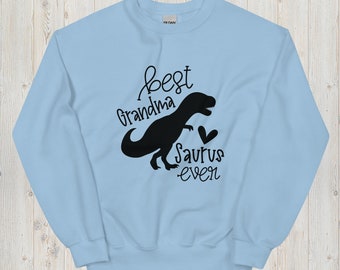 May include: Light blue sweatshirt with a black dinosaur silhouette and the text "best grandma saurus even".