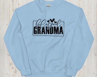 May include: Light blue sweatshirt with black text that reads "blessed grandma" in a decorative font. There are three small black hearts above the text.