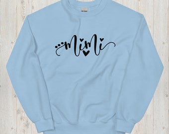May include: A light blue sweatshirt with the word "mimi" written in black cursive with small hearts around the word.