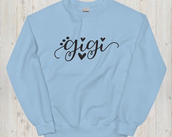 May include: A light blue sweatshirt with the word "gigi" written in black cursive script with small hearts around it.