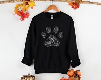 May include: Black sweatshirt with a white paw print design. The paw print is made up of the words "Fido" and "Rover" repeated multiple times.