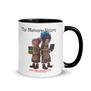 Puede incluir: Taza de cerámica blanca con interior y asa negros. La taza presenta una ilustración de dos mujeres caricaturescas etiquetadas como "The Malware Sisters". Una sostiene libros, la otra un portátil. El texto "***BEWARE***" está debajo.