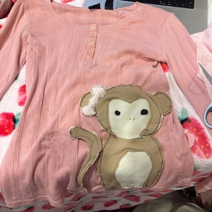 May include: A set of three ceramic mugs with a speckled, matte finish. Each mug features a different color: light blue, cream, and gray. The mugs have a simple, modern design and a comfortable handle.