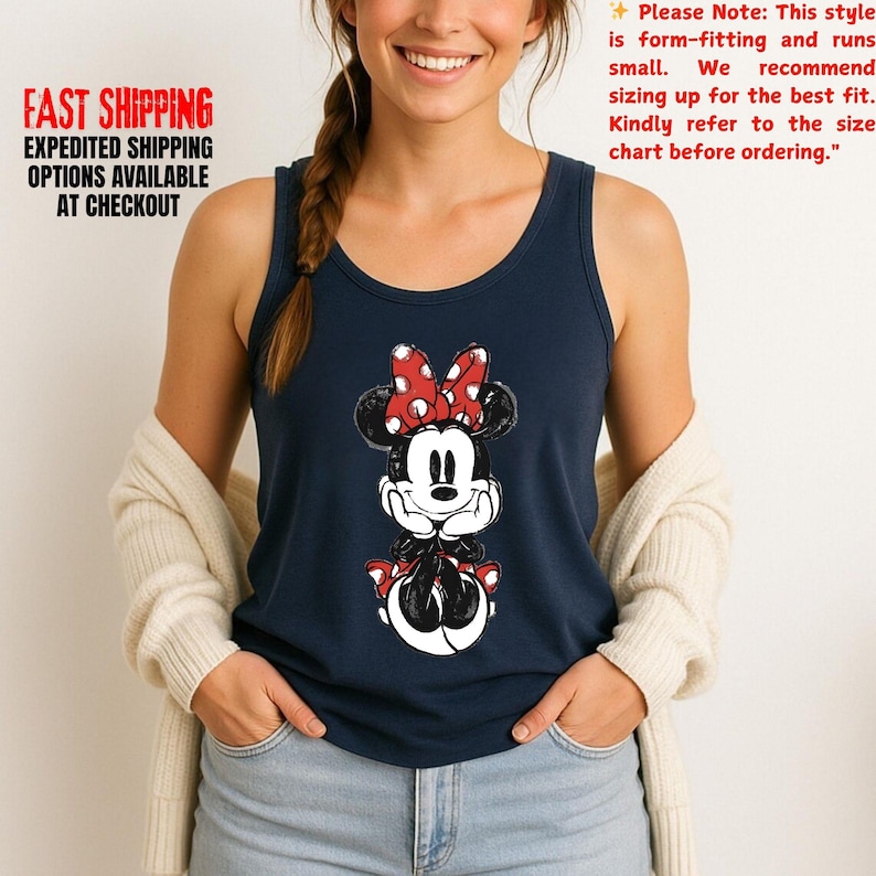 May include: Navy blue tank top featuring a Minnie Mouse graphic with a red bow and polka dots. The text "FAST SHIPPING EXPEDITED SHIPPING OPTIONS AVAILABLE AT CHECKOUT" is printed on the left side. The text "Please Note: This style is form-fitting and runs small..." is on the right.