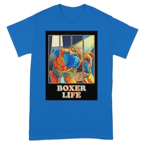 May include: A blue t-shirt featuring a colorful graphic of two Boxer dogs behind bars. The dogs are depicted in shades of orange, blue, and yellow. The words "BOXER LIFE" are printed in white and orange.