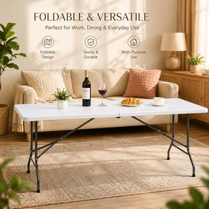 May include: A rectangular white folding table with a smooth surface and thin black metal legs. The table features the text FOLDABLE & VERSATILE, Perfect for Work, Dining & Everyday Use, along with icons for Foldable Design, Sturdy & Durable, and Multi-Purpose Use.
