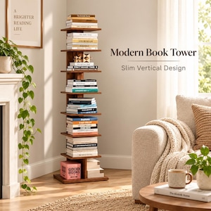 May include: A tall, slim, vertical wooden book tower featuring multiple horizontal shelves stacked in a column. The unit is filled with various books of different sizes and colors, with a pink box labeled GOOD BOOKS at the base.