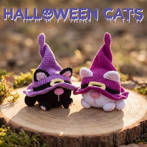 May include: Two crocheted cat figures wearing purple witch hats, sitting on a wooden surface. One cat is black, the other is white. The hats have black bands and yellow accents. The text "HALLOWEEN CATS" is above the cats.