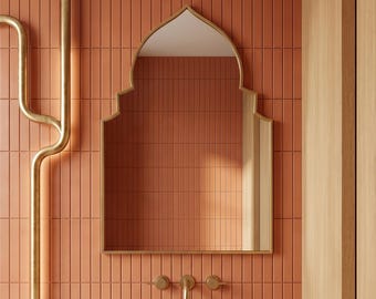 May include: A modern bathroom design with a peach-toned tiled wall, a marble countertop with a built-in sink, and a gold-framed mirror. Gold taps and a towel rail enhance the luxurious feel. The design is contemporary and stylish.