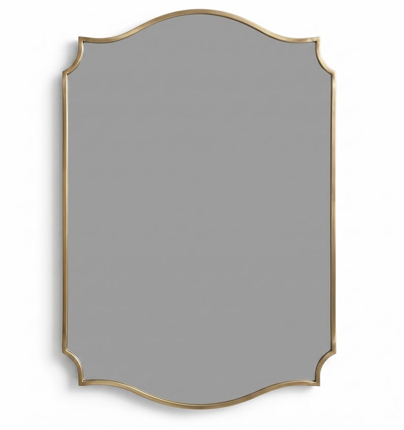 Minimal brass scalloped mirror on white background