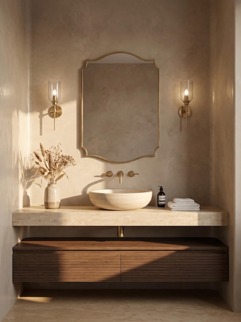 Gold brass mirror above modern bathroom vanity
