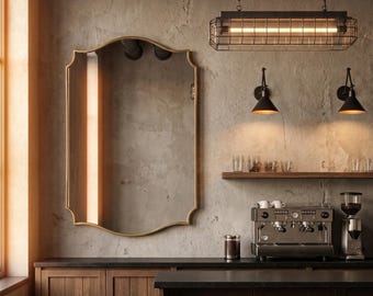 May include: Interior of a coffee shop with a large gold-framed mirror, wooden cabinets, and a coffee machine. A rectangular light fixture hangs from the ceiling. The walls are textured, creating a rustic atmosphere.